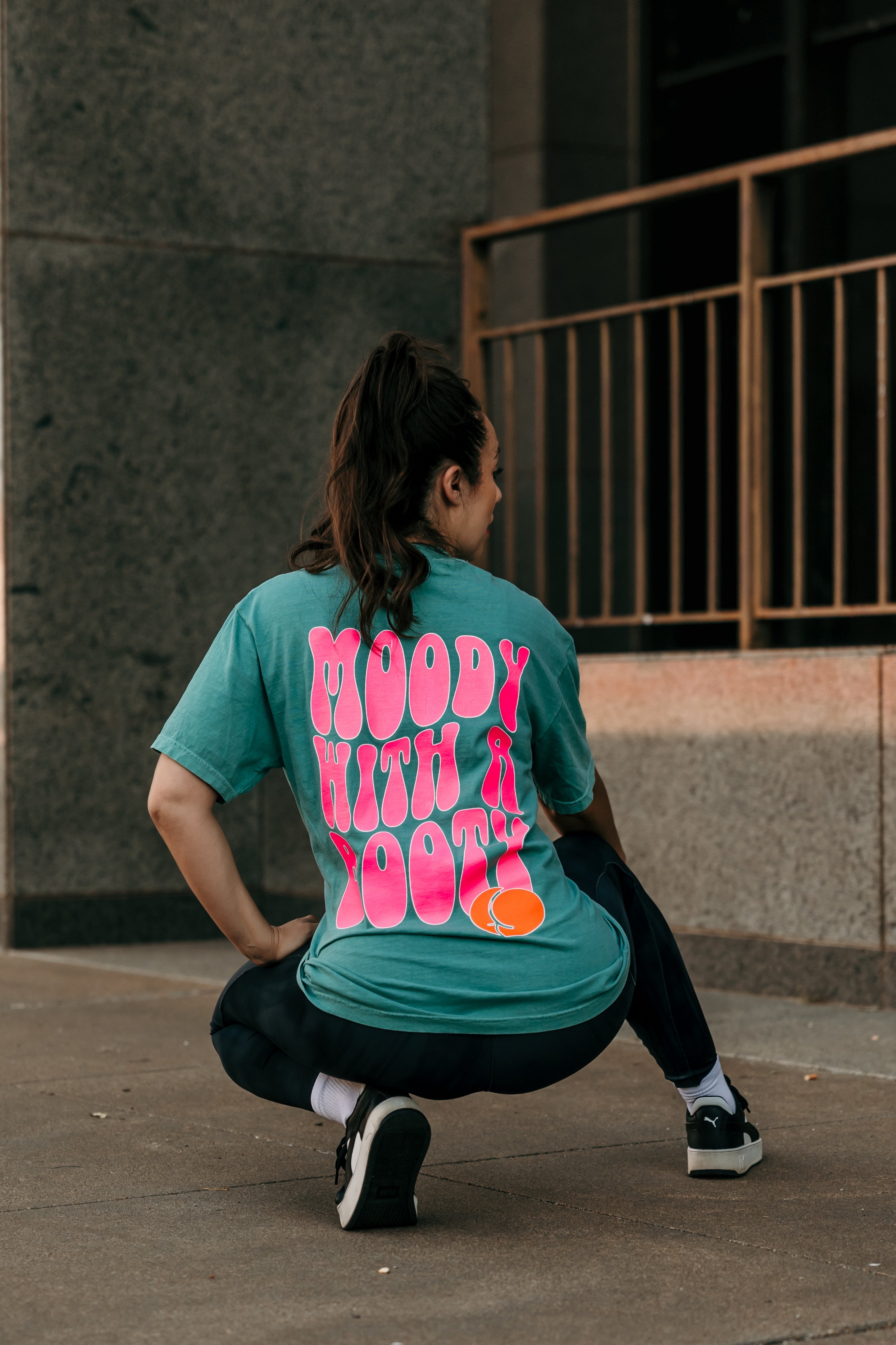 Moody with a booty graphic t-shirt by Shop Karma Tees, featuring bold print and casual fit on a white cotton tee.