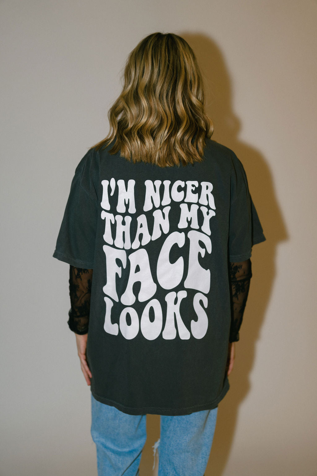 Nicer Than My Face Looks graphic T-shirt by Shop Karma Tees, featuring bold text design on a casual black tee.