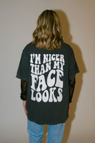 Nicer Than My Face Looks graphic T-shirt by Shop Karma Tees, featuring bold text design on a casual black tee.
