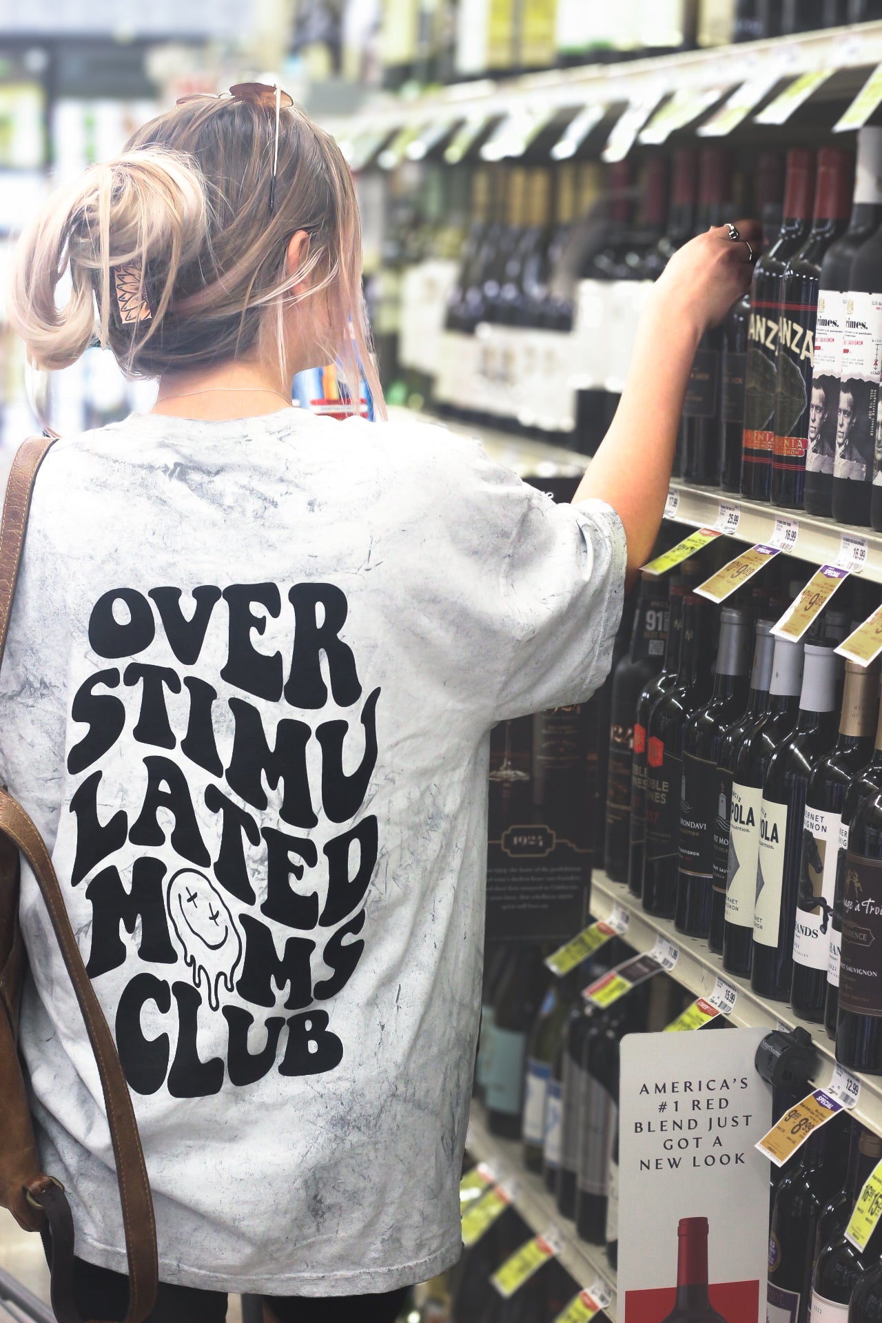 Overstimulated Moms Club graphic t-shirt by Shop Karma Tees, featuring bold text and casual fit in a comfortable cotton fabric.