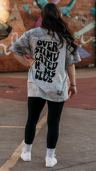 Overstimulated Moms Club graphic T-shirt by Shop Karma Tees, featuring a colorful design on a casual cotton tee.