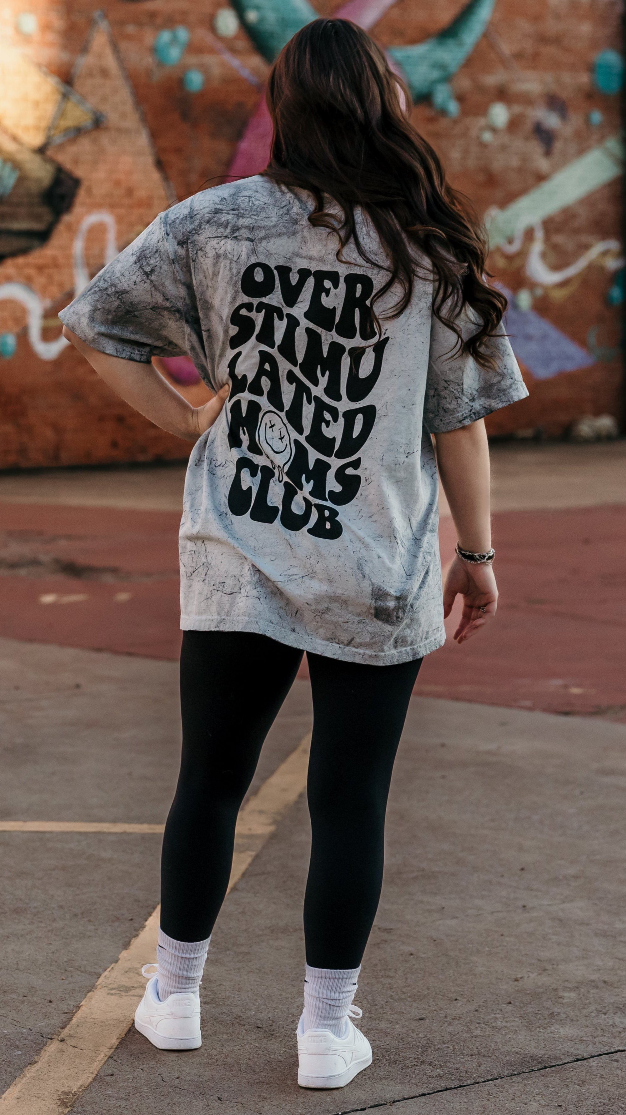 Overstimulated Moms Club graphic T-shirt by Shop Karma Tees, featuring a colorful design on a casual cotton tee.