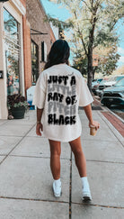 Ray of Pitch Black Graphic Tee from Shop Karma Tees, featuring a bold black t-shirt with a distinctive graphic design.