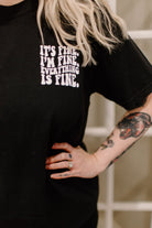 It's Fine graphic tee by Shop Karma Tees featuring a stylish design on soft fabric, perfect for casual wear.