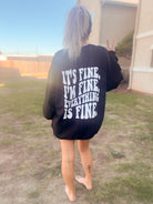 It's Fine graphic tee from Shop Karma Tees featuring a casual design with bold "It's Fine" text on soft fabric.