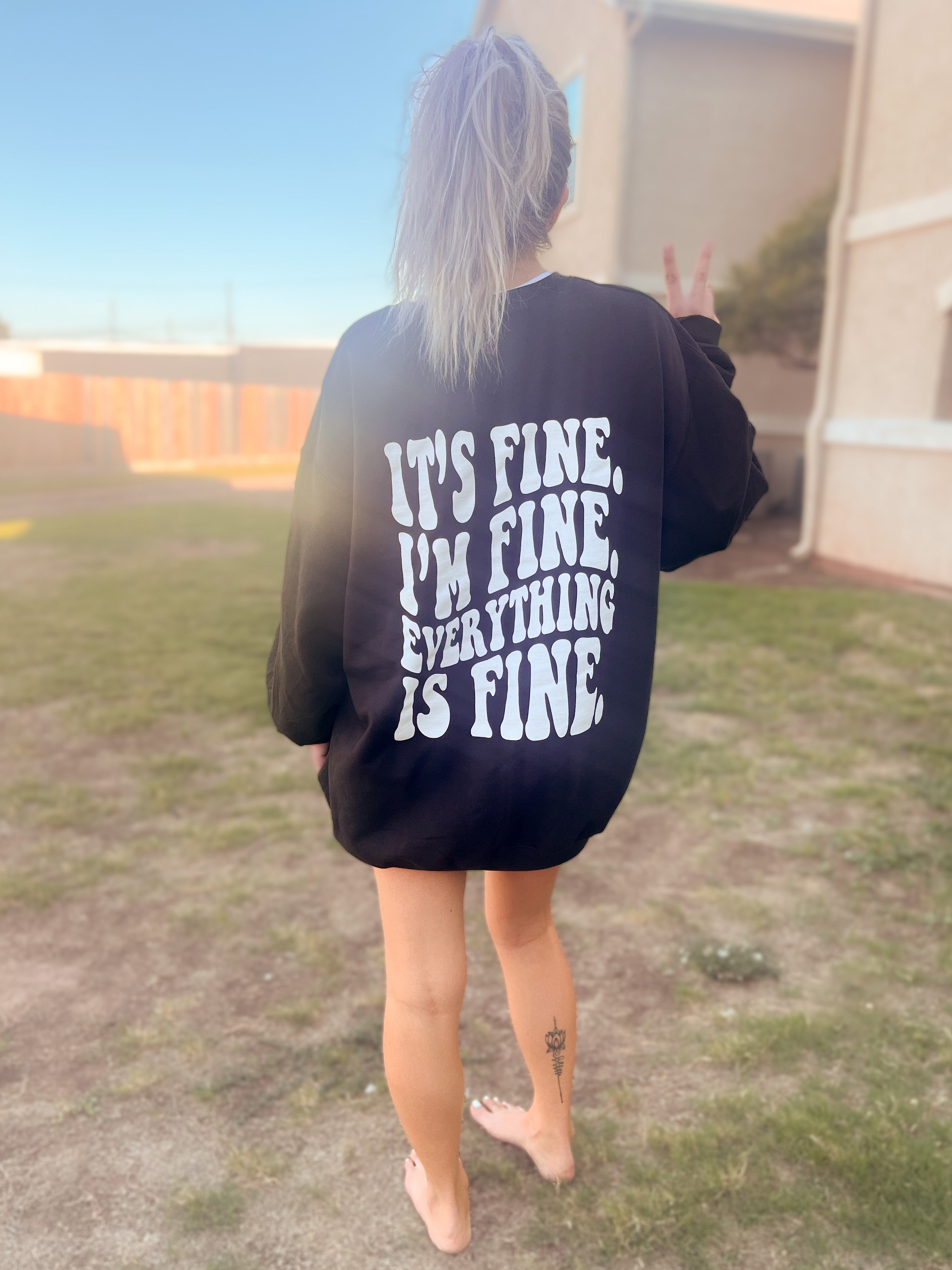 It's Fine graphic tee from Shop Karma Tees featuring a casual design with bold "It's Fine" text on soft fabric.