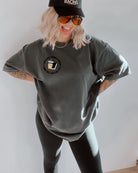Spicy Books graphic T-shirt from Shop Karma Tees featuring colorful book illustrations and bold text design.