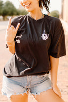 Black graphic tee from Shop Karma Tees featuring the "Staying Alive" design with bold text and vintage-inspired artwork.