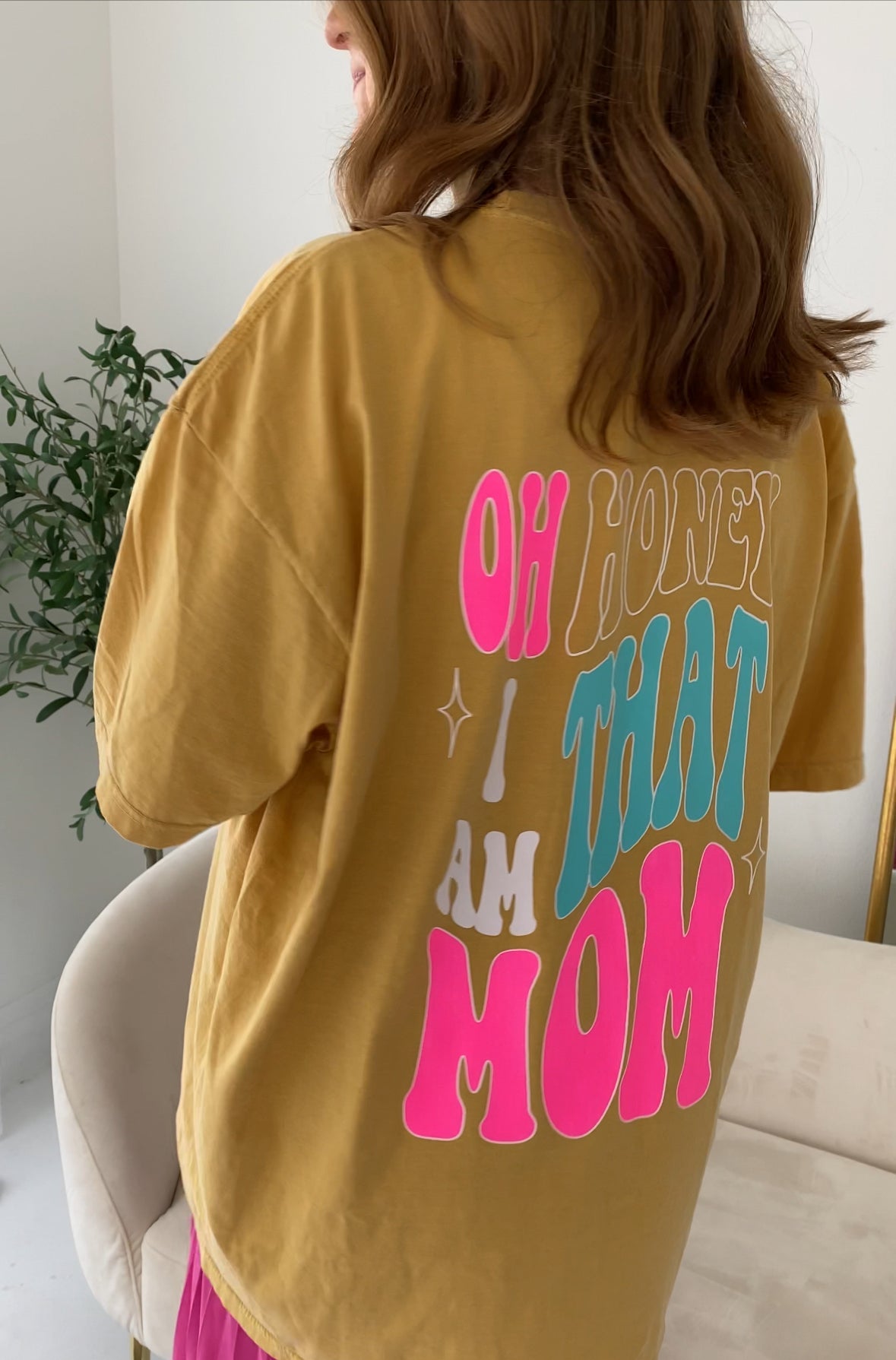 That Mom graphic T-shirt from Shop Karma Tees, featuring a casual fit with a bold "Mom" graphic on the front.