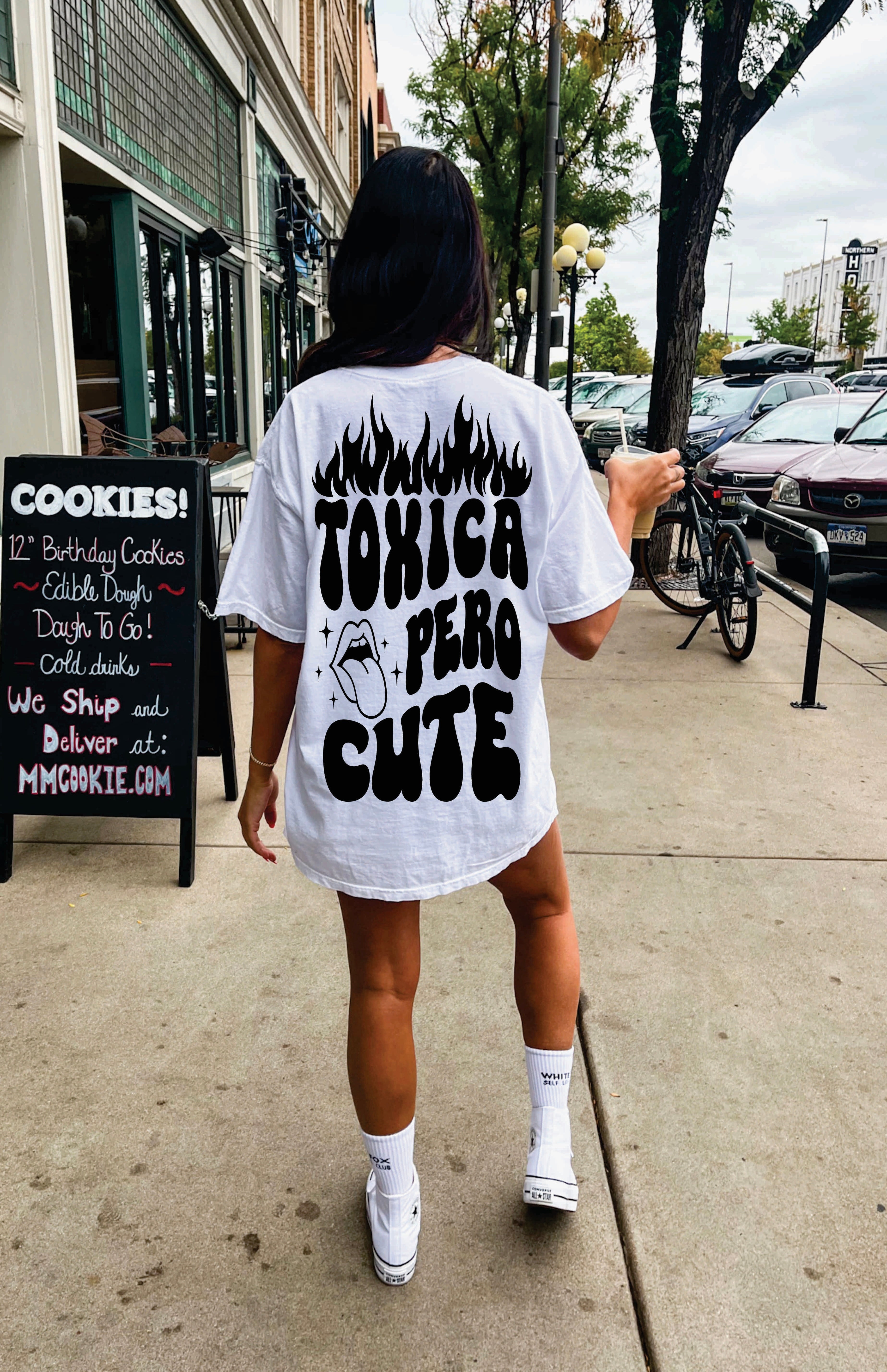 Toxica Pero Cute graphic T-shirt by Shop Karma Tees featuring a colorful, playful design on a black fabric background.