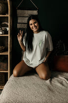 Vibin' Graphic Tee by Shop Karma Tees showing a colorful, relaxed-fit t-shirt with vibrant graphic design on the front.