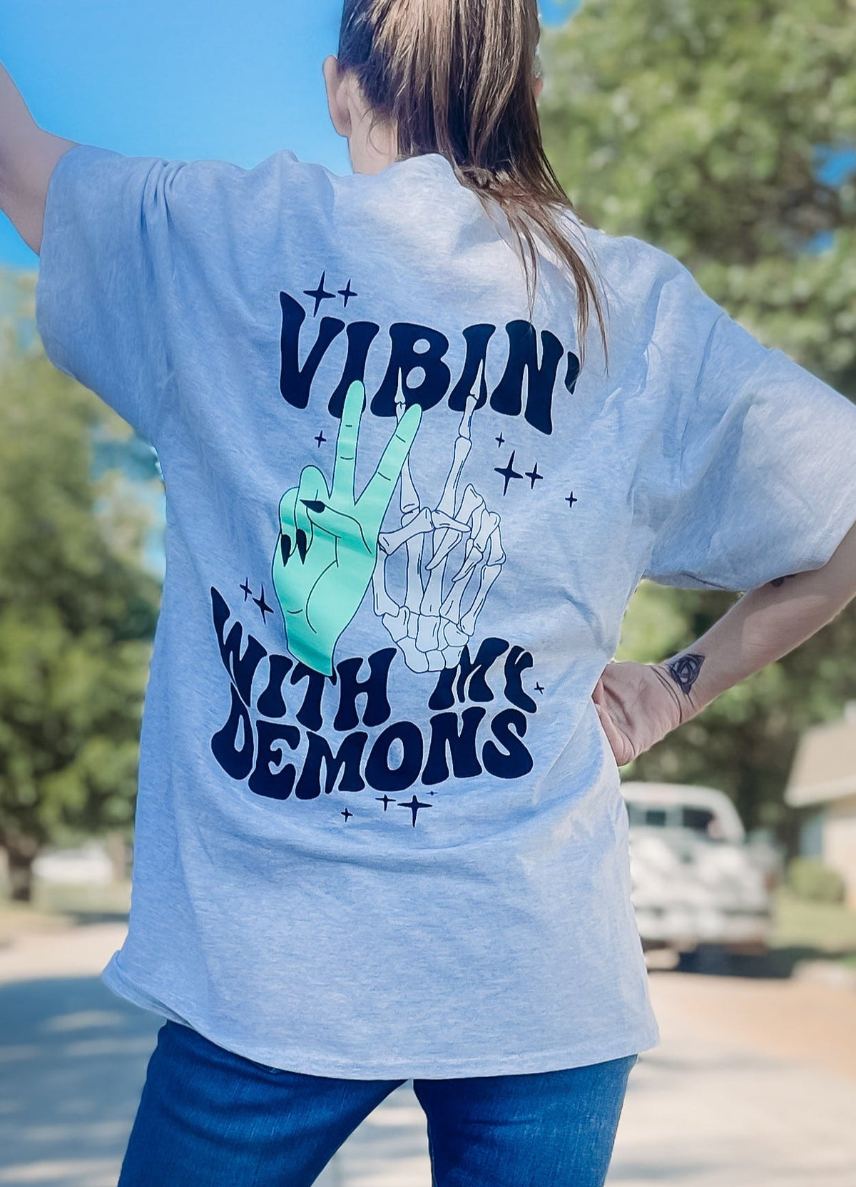 Vibin' Graphic Tee by Shop Karma Tees displayed on a hanger, featuring colorful retro-inspired design on a soft cotton T-shirt.