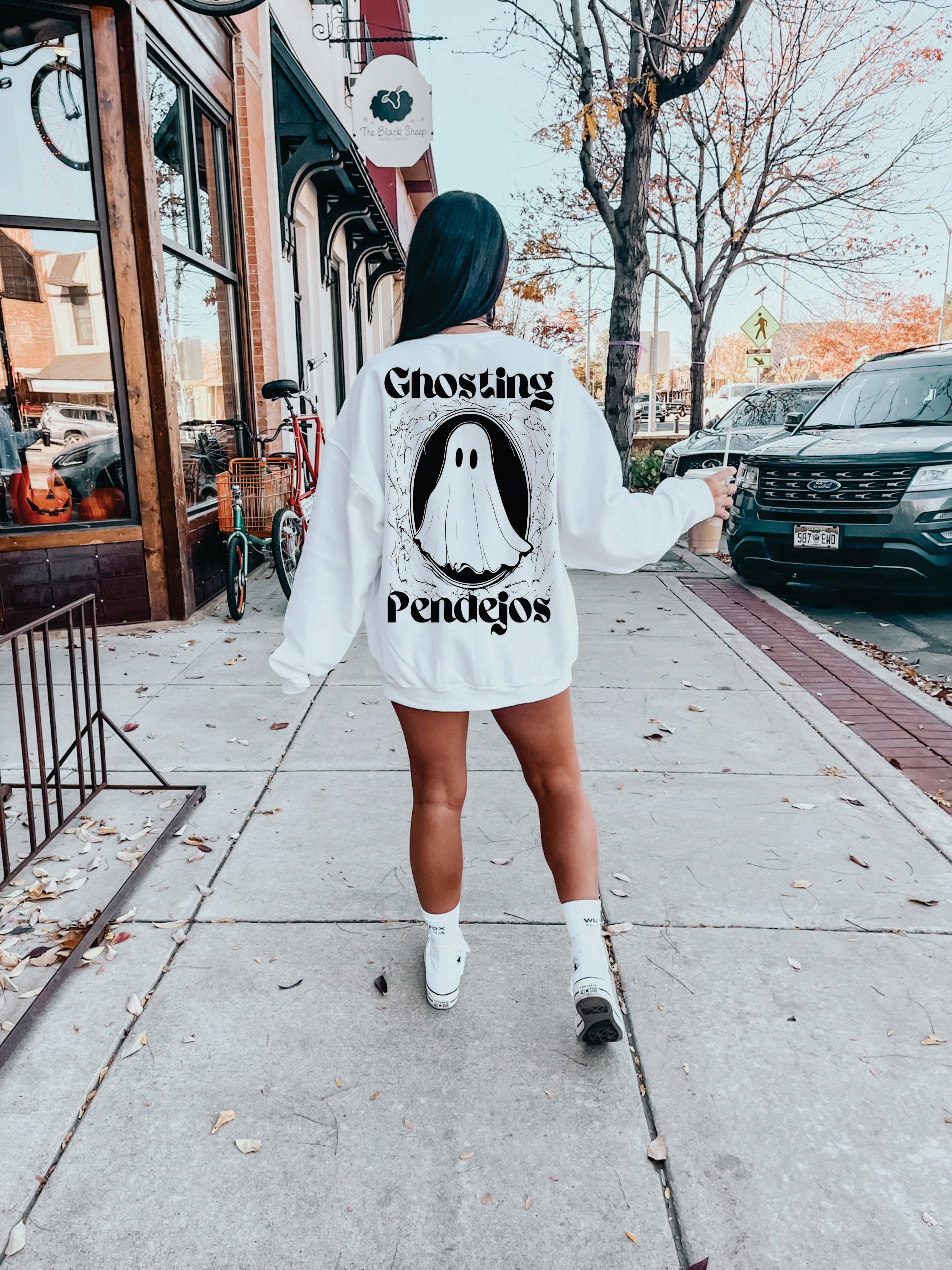 Ghosting Pendejos Pullover by Shop Karma Tees, close-up of the black crewneck sweatshirt with the printed design visible.