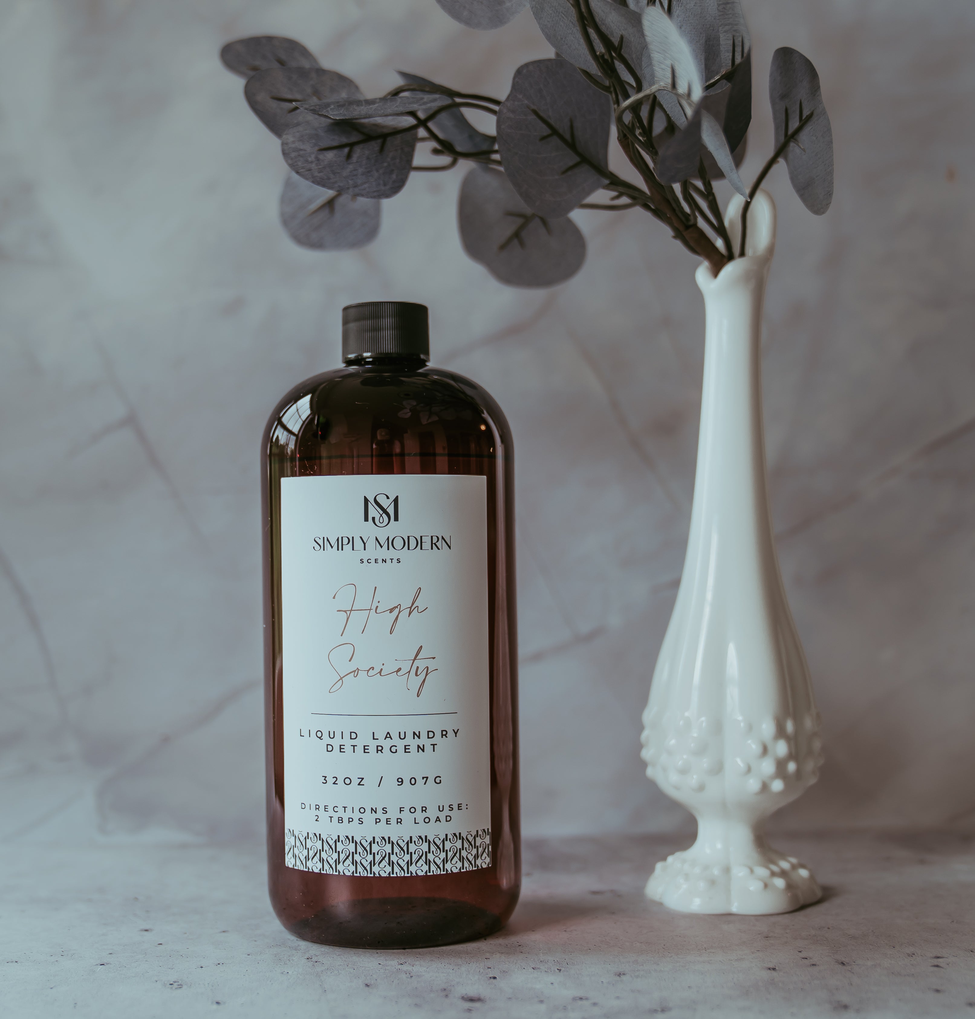 Simply Modern Scents 32oz Luxury Laundry Detergent bottle with Midnight Tide fragrance, showcasing elegant packaging and label design.