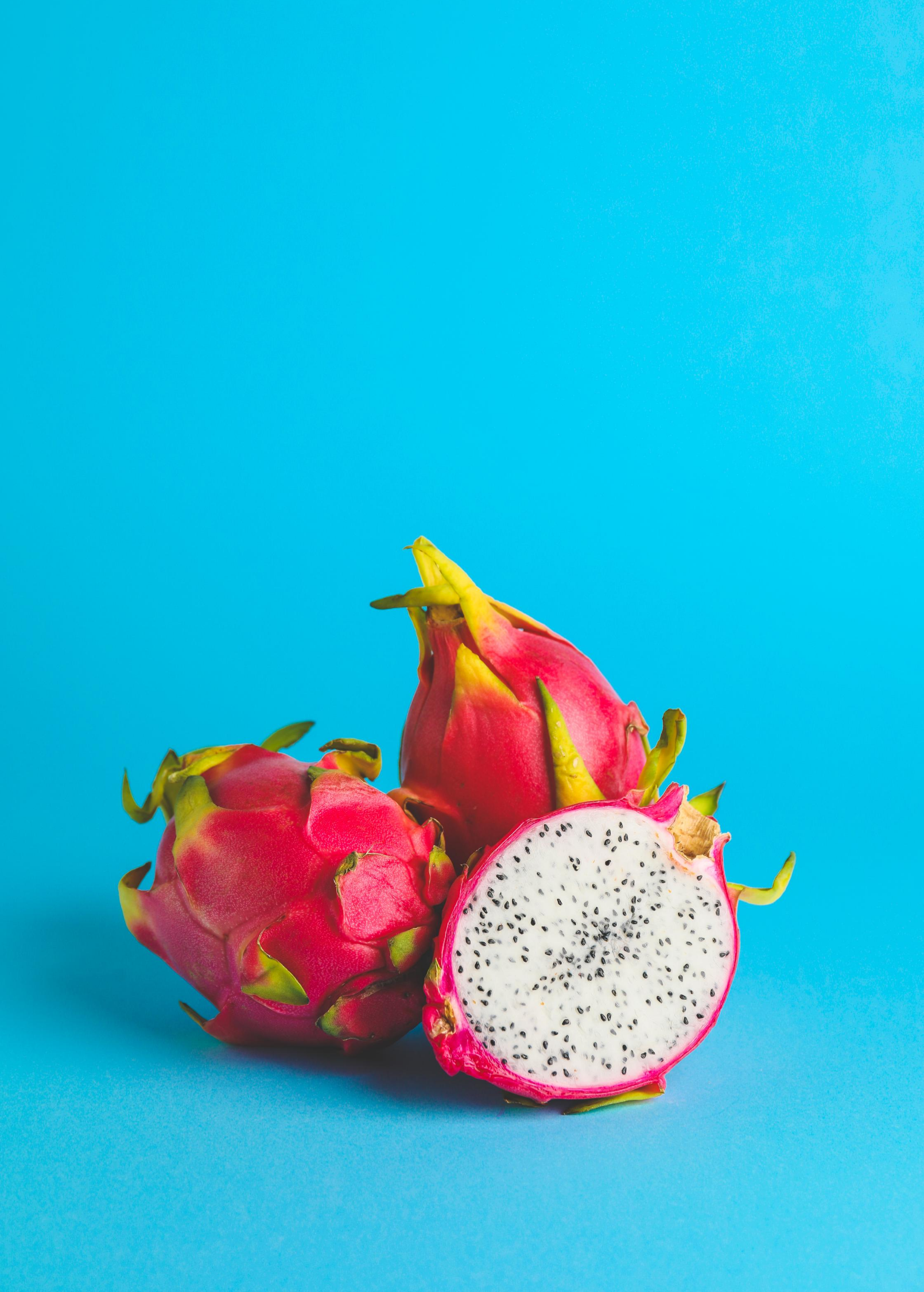 White Vietnamese Jaina dragon fruit plant in a coconut coir pot, showcasing its lush green stems and vibrant fruiting features.