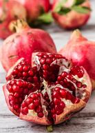 Large pomegranate Parfianka tree from Sow Exotic in burlap pot, tropical fruit tree with lush green foliage and fruit-bearing branches.