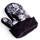 Purple and black kitchen oven mitts featuring witch and herbal designs from the Spirit Nest Kitchen Witch Oven Mitt Set.