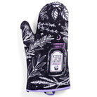 Pair of Spirit Nest Kitchen Witch oven mitts featuring purple, black, and white witch herb designs for kitchen use.