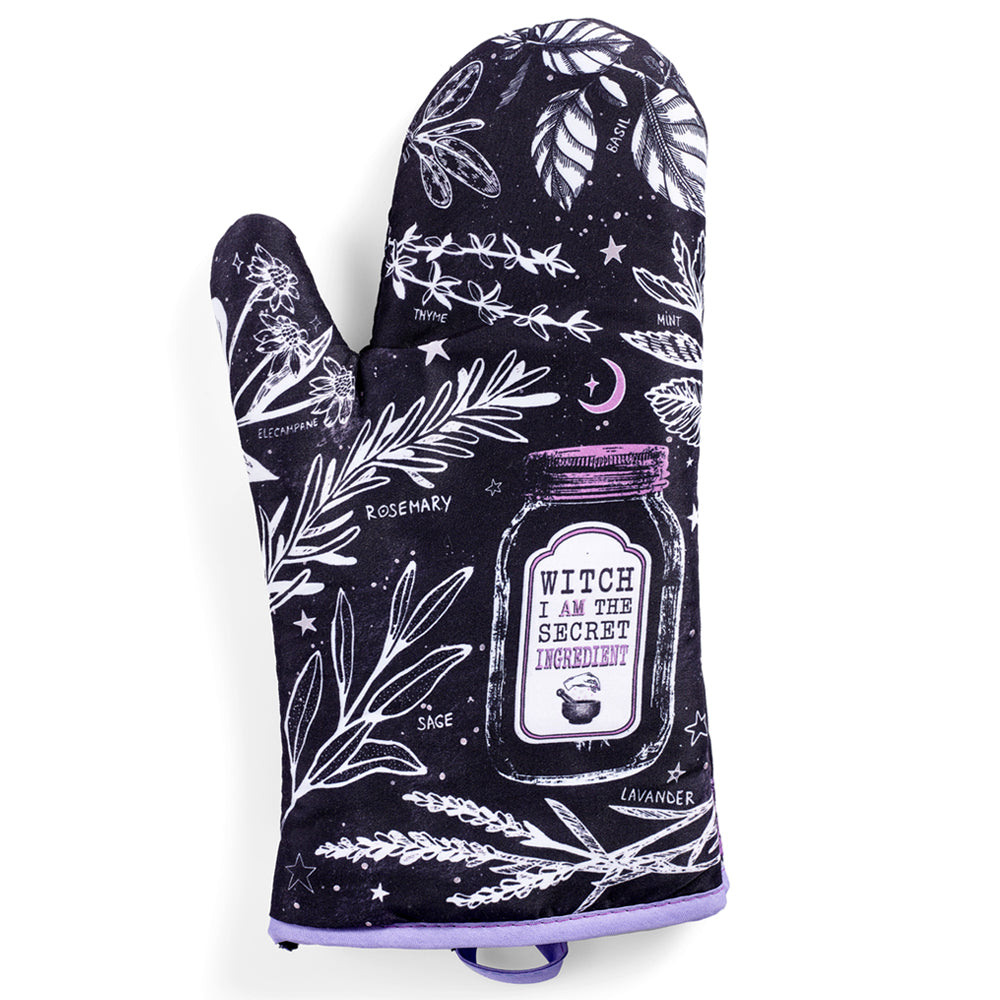 Purple and black witch herb-themed oven mitts from Spirit Nest, part of the Kitchen Witch oven mitt set, with a witch and herbs design.