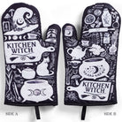 Pair of purple, black, and white kitchen witch oven mitts with herb motifs from Spirit Nest Kitchen Witch Oven Mitt Set.