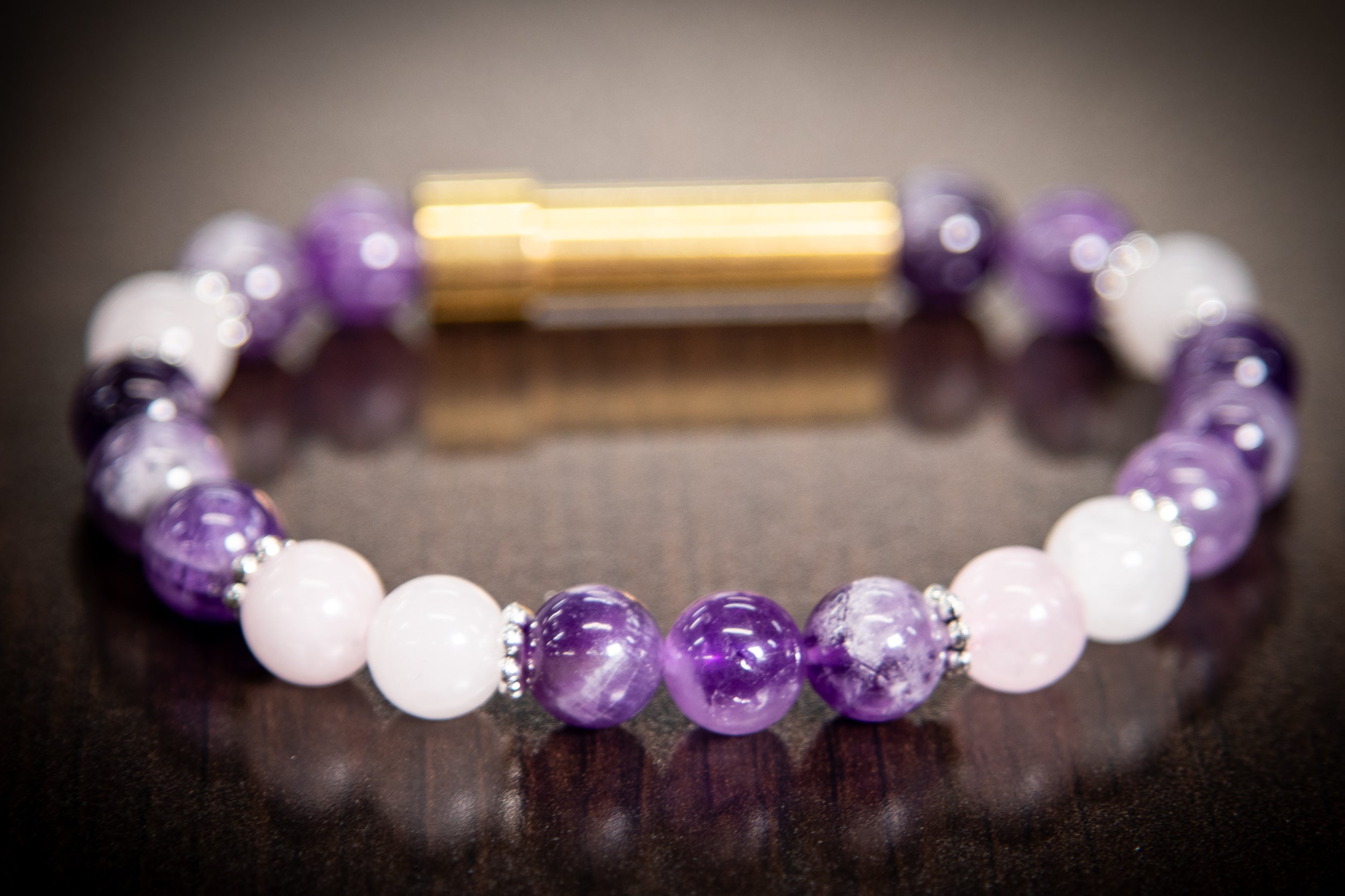Silver cremation jewelry bracelet with amethyst and rose quartz stones, designed for hair, fur, or ash keepsakes.