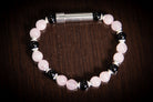 Silver cremation jewelry bracelet with rose quartz and onyx stones, designed for hair, fur, or ash keepsakes.