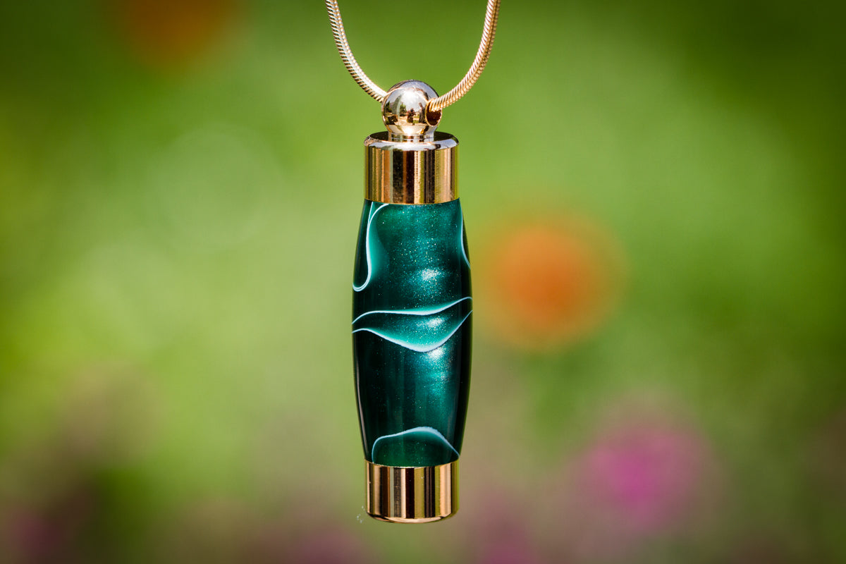 Emerald acrylic memorial pendant by Spirit Pieces for cremation ash or hair, designed as a keepsake urn with a sleek pendant style.