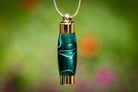 Emerald acrylic memorial pendant by Spirit Pieces for cremation ash or hair, designed as a keepsake urn with a sleek pendant style.