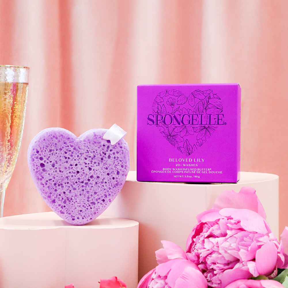 Spongellé Beloved Lily Heart Buffer, a body wash infused exfoliating buffer with floral lily scent, soft texture, and heart shape.