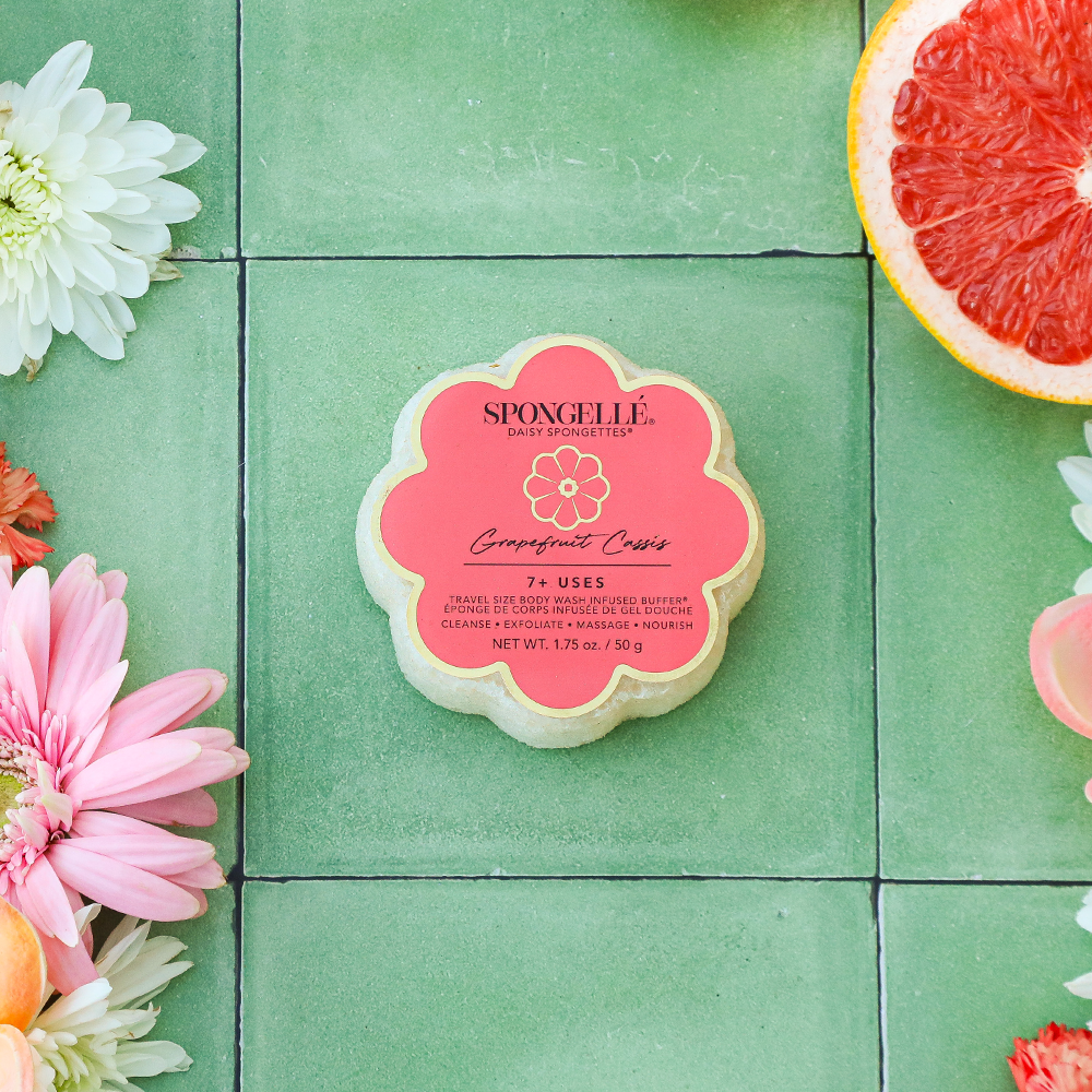 Spongellé Grapefruit Cassis Daisy Spongette body wash-infused buffer with vibrant yellow and purple floral design.