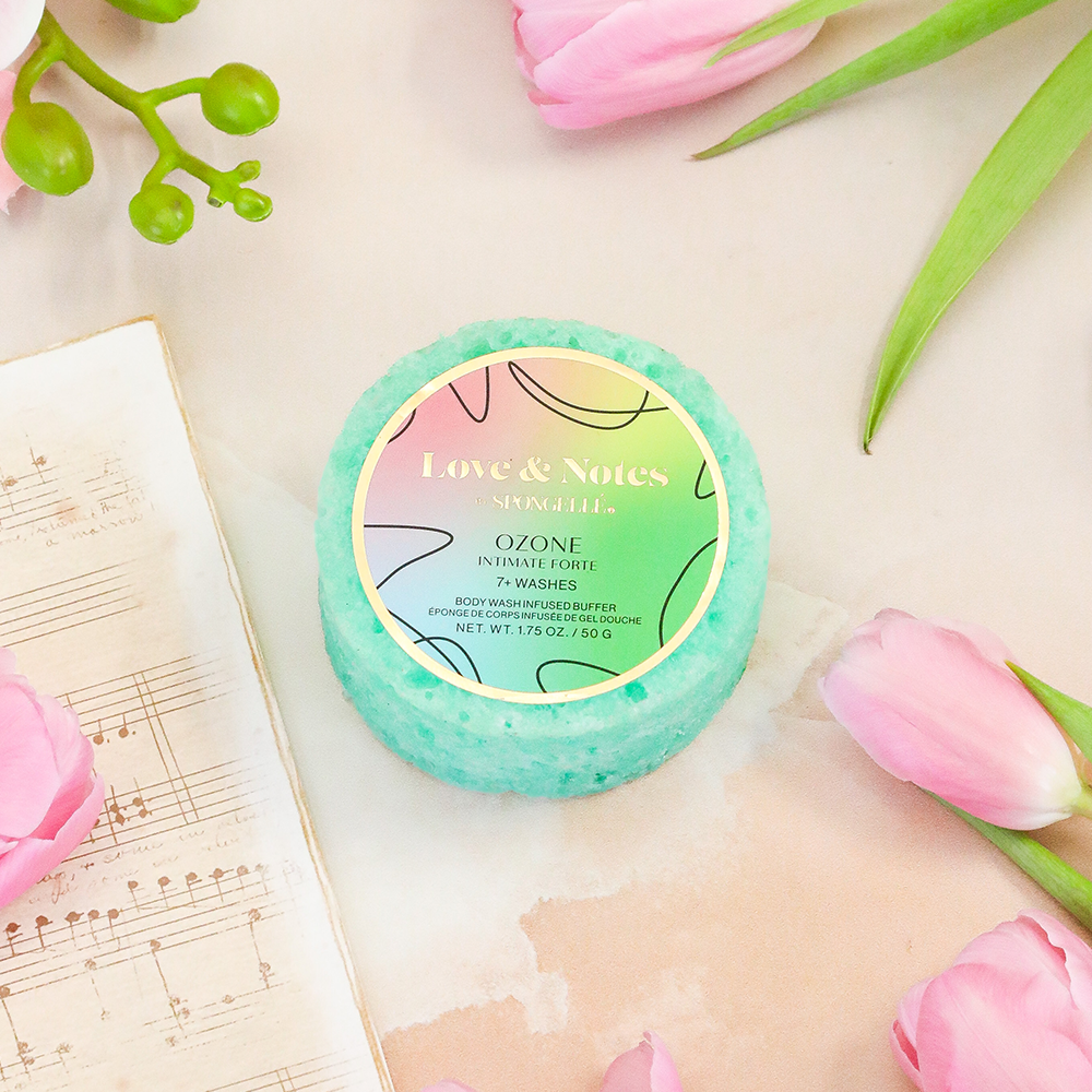 Spongellé Intimate Forte Love & Notes body wash-infused buffer sponge with floral and fruity scent, textured for gentle exfoliation.