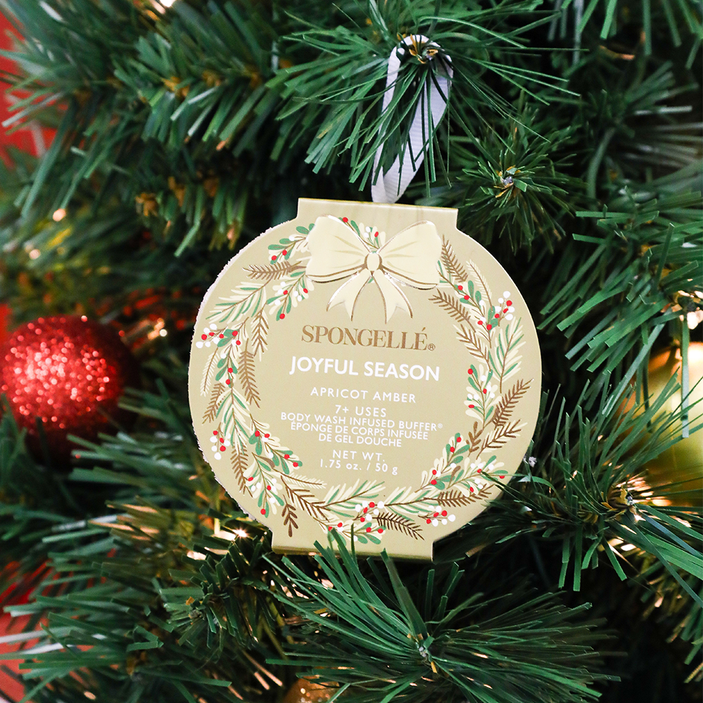 Spongellé Joyful Season Apricot Amber Body Wash Infused Buffer with holiday wreath design, showcasing festive scent and textured surface.