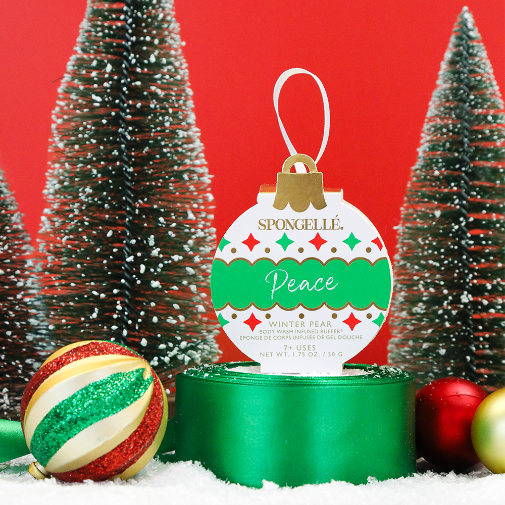 Spongellé Peace Winter Pear Body Wash Infused Buffer as a holiday ornament with festive design and textured body wash buffer appearance.