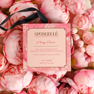 Spongellé Peony Flower body wash-infused buffer in a boxed floral design, soft pink and white peony pattern visible.