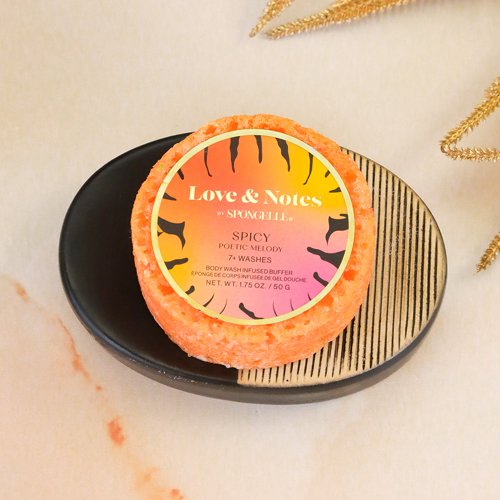 Spongellé Poetic Melody Love & Notes body wash-infused buffer sponge with floral design and soft texture for gentle cleansing.