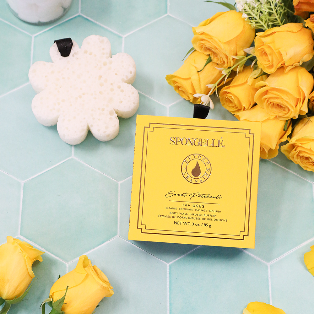 Spongellé Sweet Patchouli Body Wash Infused Buffer in boxed flower packaging, soft exfoliating buffer with floral scent.