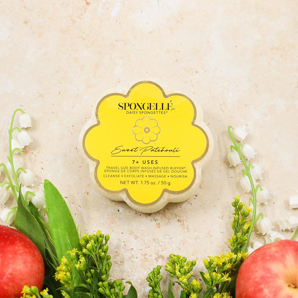 Spongellé Sweet Patchouli Daisy Spongette body wash-infused buffer with floral design and soft texture for gentle cleansing.