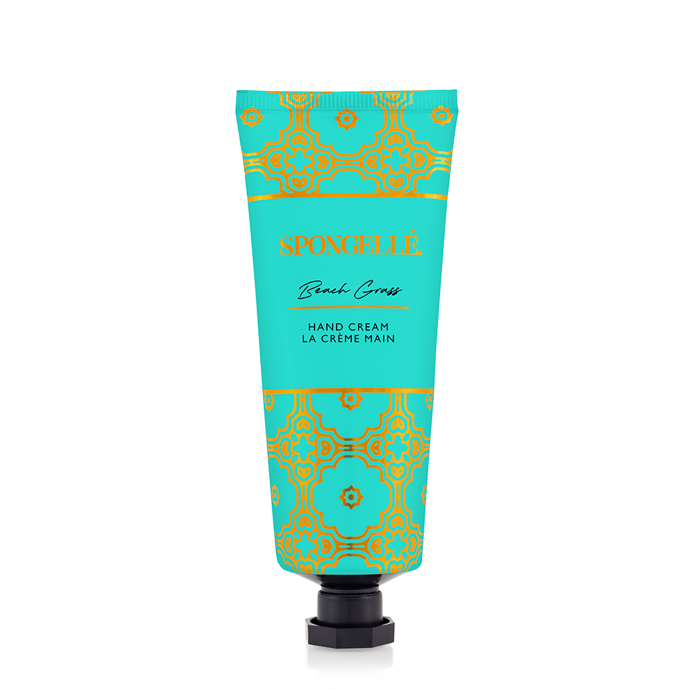 Spongellé Beach Grass hand cream in a tube with a floral and grass design, showcasing its moisturizing formula and natural ingredients.