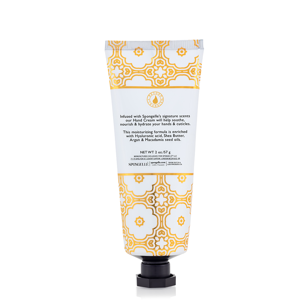 Spongellé Freesia Pear hand cream tube with floral design and label, showcasing the nourishing skincare product.