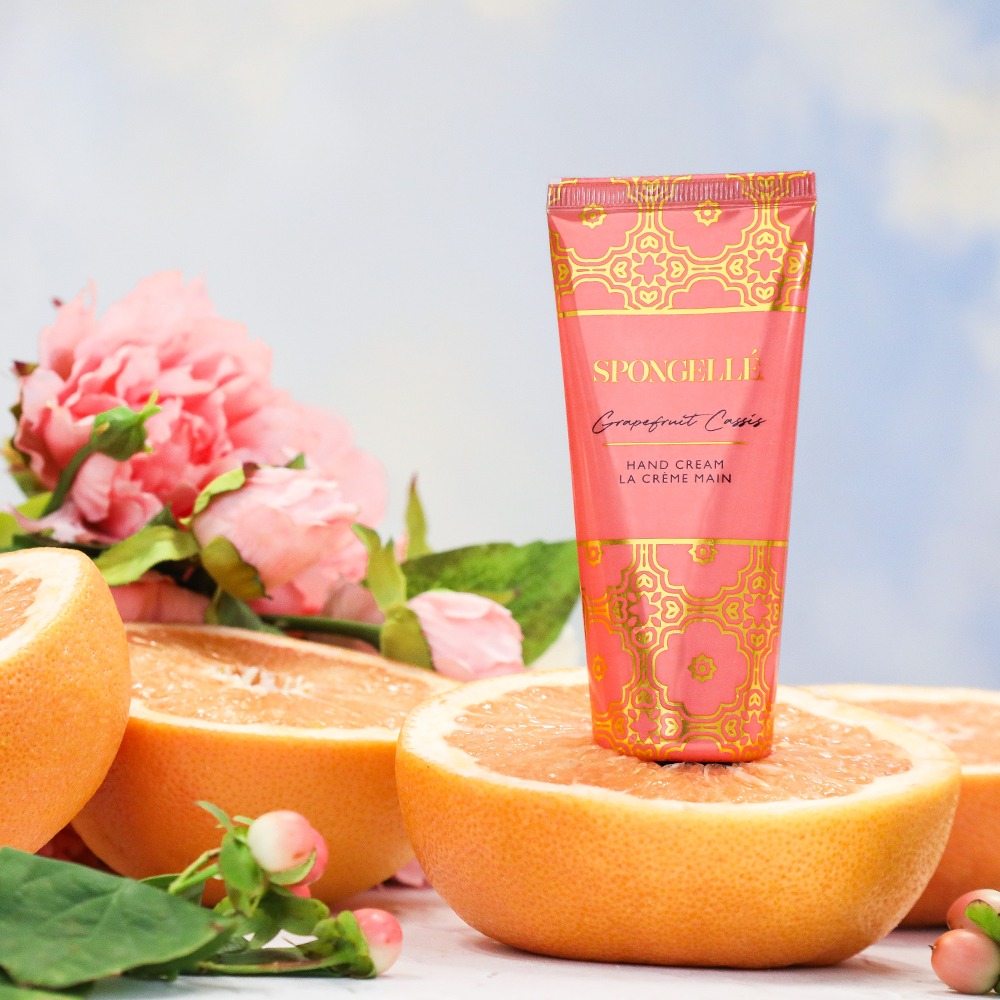 Spongellé Grapefruit Cassis hand cream in a sleek tube, featuring a citrus and berry scent, perfect for nourishing hands.