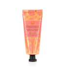 Spongellé Grapefruit Cassis hand cream tube showing floral design and product label with citrus and berry scent branding.