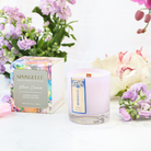 Black Orchid Private Reserve Candle by Spongellé, a luxurious home fragrance in a sleek black container with a flickering flame.