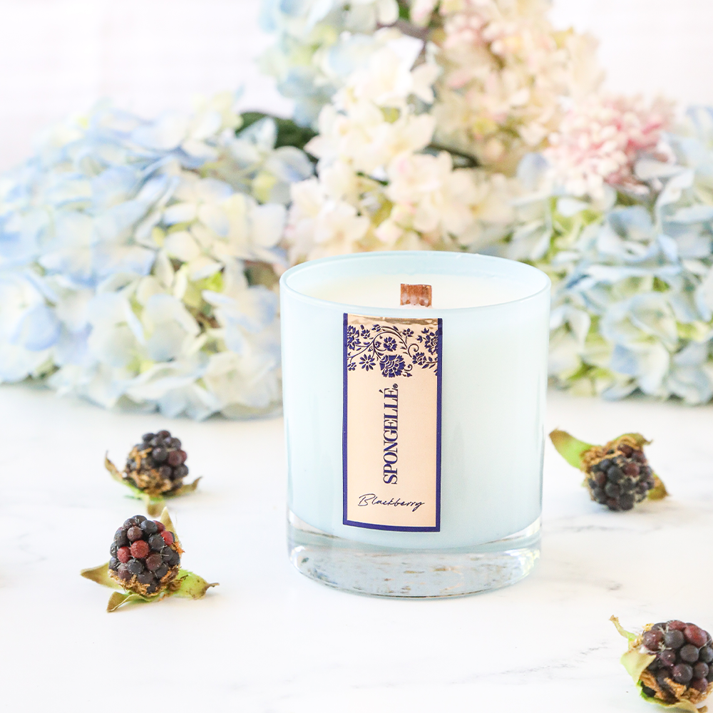 Spongellé Blackberry Private Reserve Candle displaying a black jar with a black lid and a label featuring blackberries and elegant design.