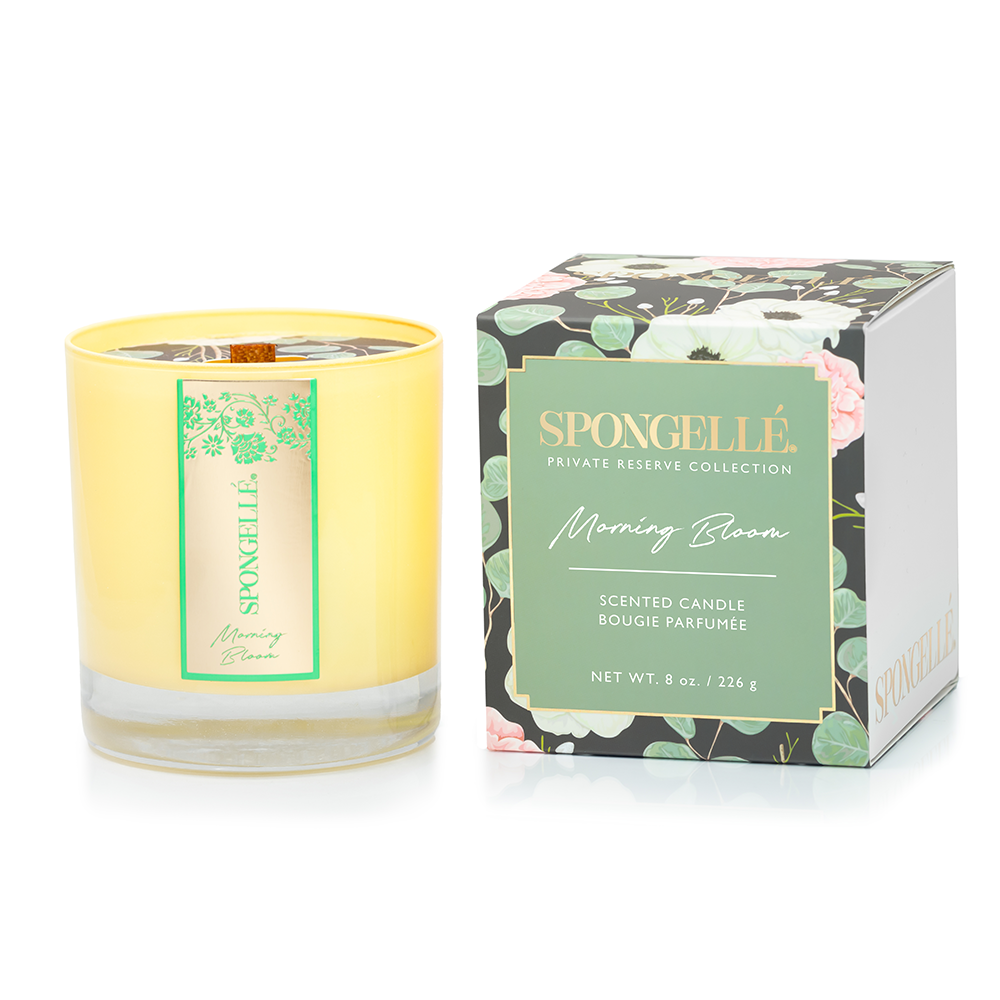 Spongellé Morning Bloom private reserve candle emitting a warm glow, ideal for home fragrance and creating a cozy atmosphere.