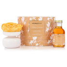 Spongellé Tobacco Vanilla Private Reserve Diffuser in a glass bottle with reed sticks, emitting warm home fragrance.