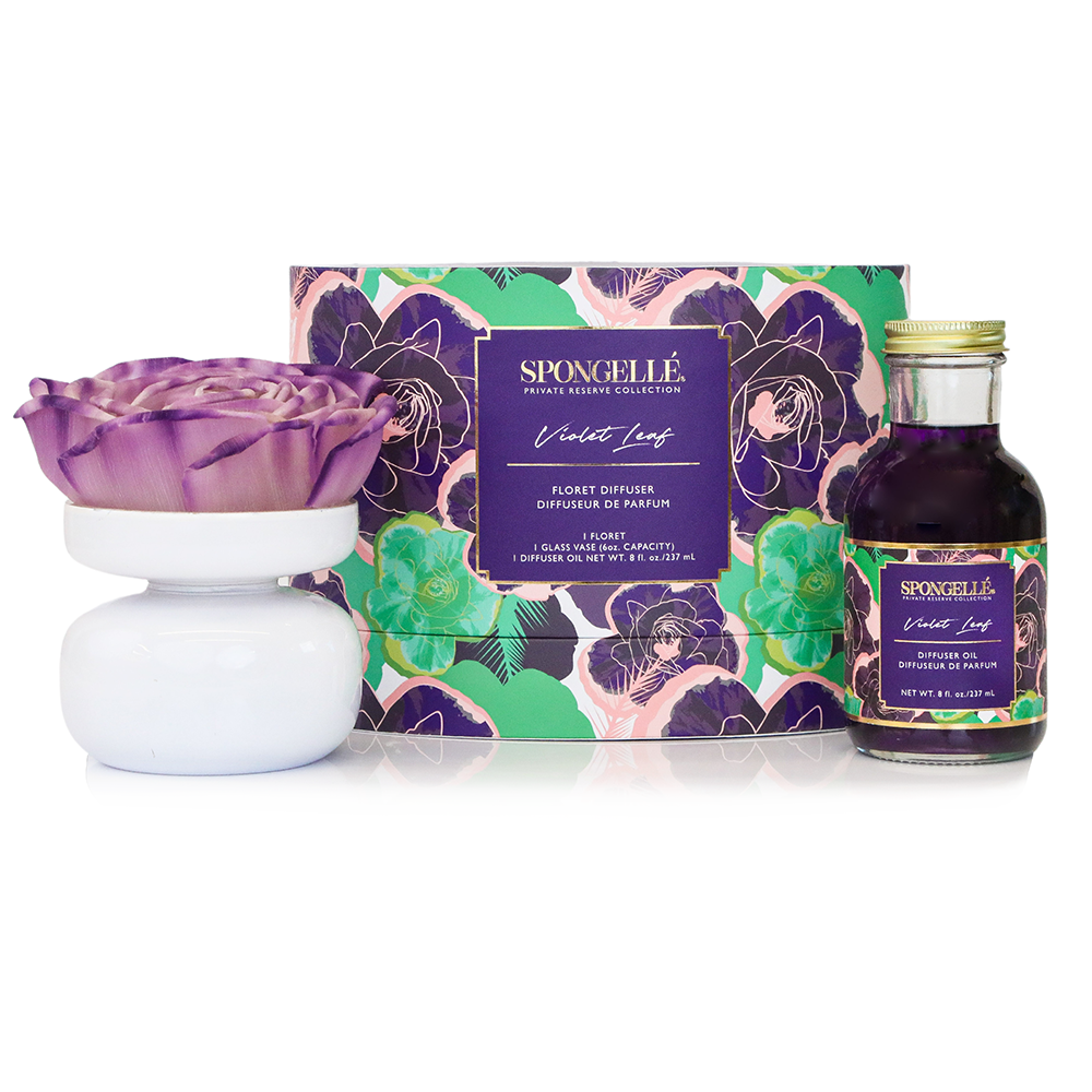 Violet Leaf Private Reserve diffuser by Spongellé, a home fragrance with a glass bottle and reed sticks for aromatic decor.