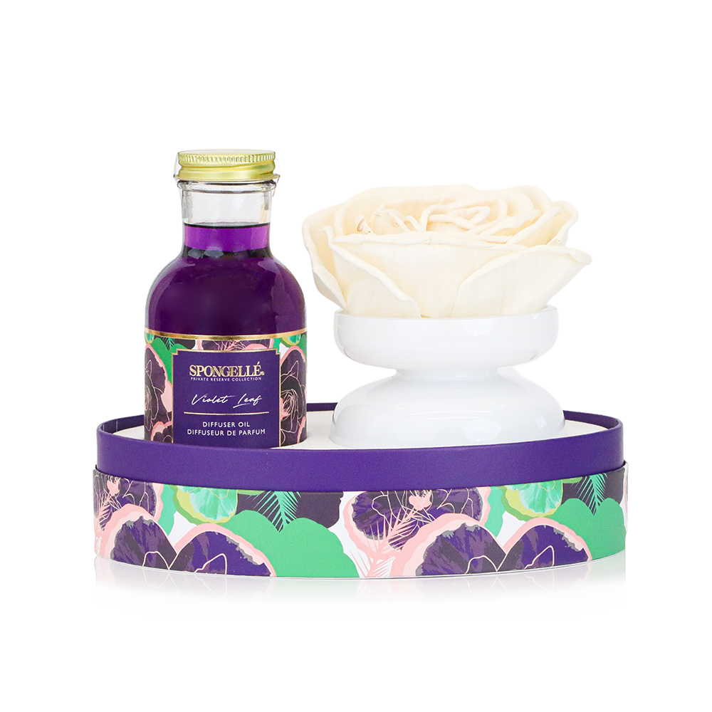 Violet Leaf Private Reserve diffuser by Spongellé, a home fragrance with a glass bottle and reed sticks for aromatic decor.