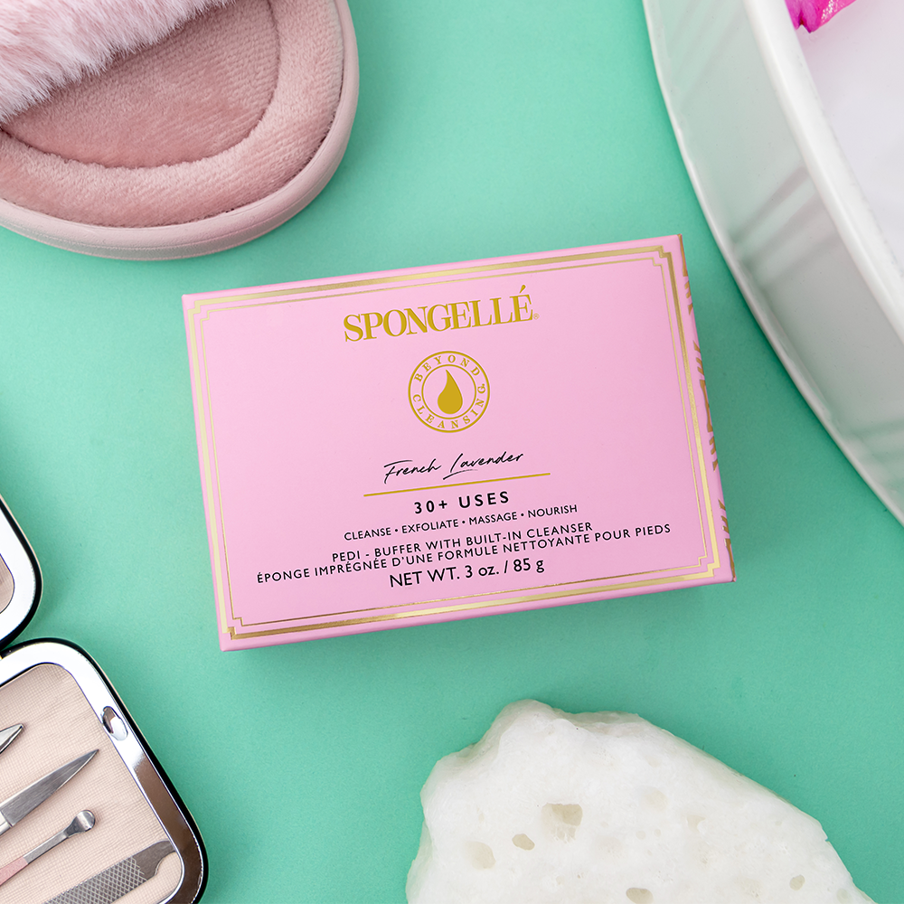 Spongellé French Lavender Pedi Buffer for smoothing and exfoliating feet with lavender-scented sponge in a close-up view.