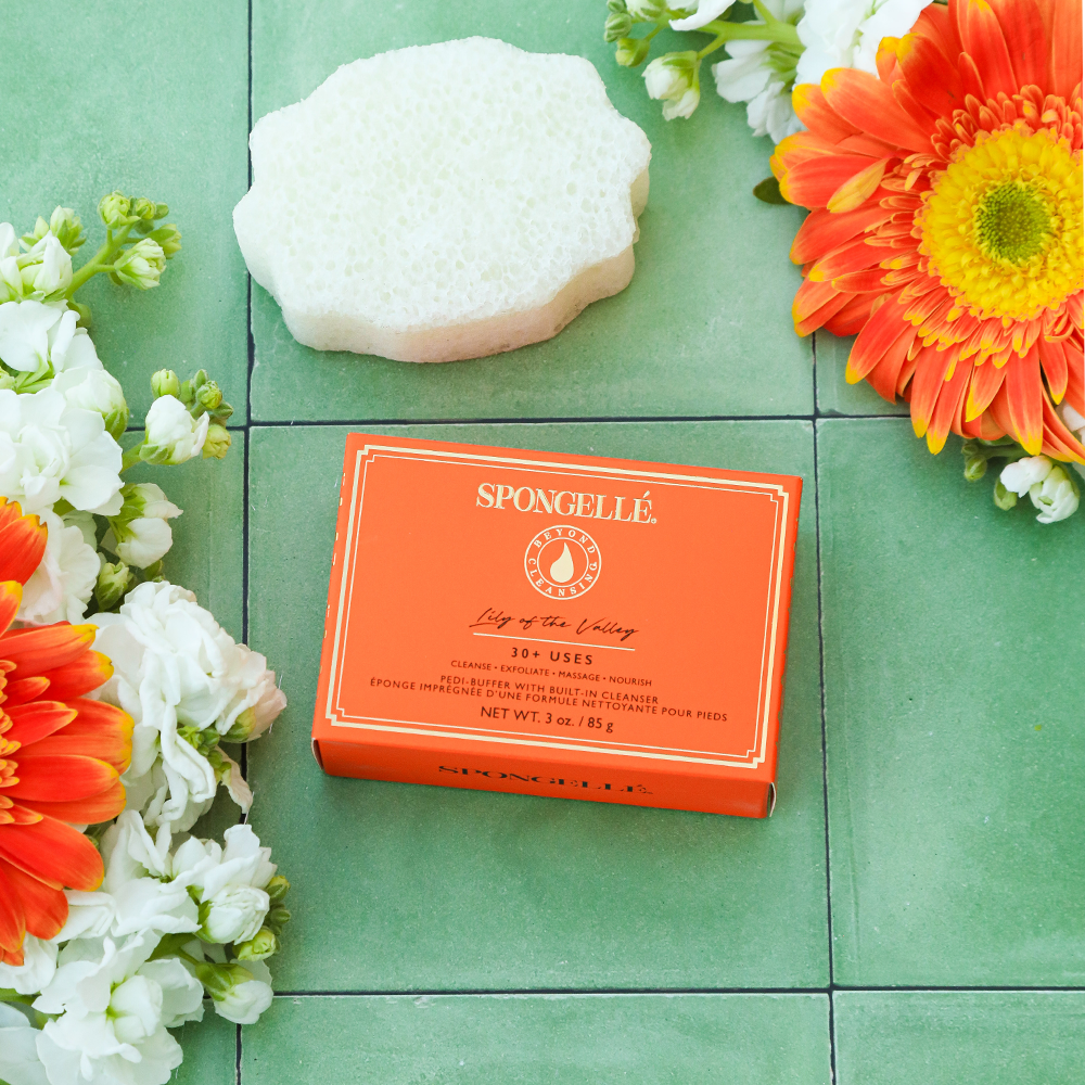 Spongellé Lily of the Valley Pedi Buffer showing textured surface for exfoliating feet and a floral design.