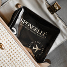 Black Spongellé travel case with zipper closure, compact design, ideal for storing toiletries and travel essentials.